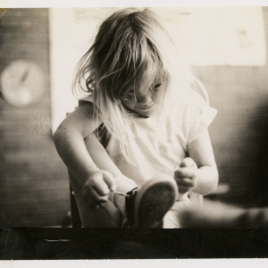 Girl tying her shoe